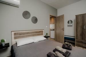 a bedroom with a large bed with a wooden headboard at AIORA yard in Ammouliani