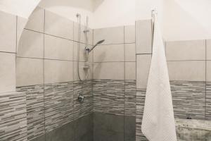a shower with a glass door in a bathroom at Meghan Home in Catania