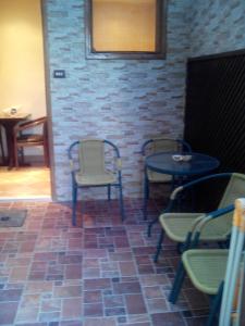Studio في شرم الشيخ: غرفة بها كراسي وطاولات وجدار من الطوب