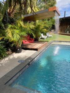 a swimming pool in a backyard with a wooden deck at thespaceperth in Perth