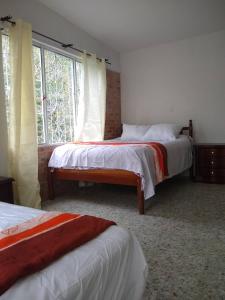 Ένα ή περισσότερα κρεβάτια σε δωμάτιο στο Kaliawiri Bird Lodge & reserve
