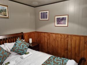 a bedroom with a bed and two pictures on the wall at Roland B&B in Claude Road