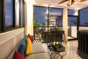 a living room with a couch and a large window at Hanoi Media Hotel & Spa in Hanoi