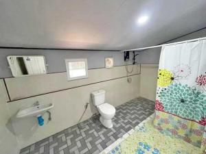 a bathroom with a toilet and a sink at EiDI Homestay in Nong Kung Si