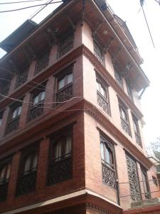 a tall brick building with windows on the side of it at Ecotel Guest House in Bhaktapur