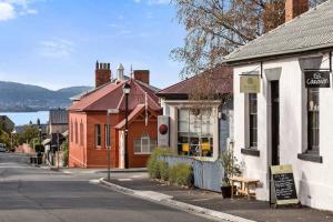 an empty street in a small town with buildings at Berwick Cottage in Hobart