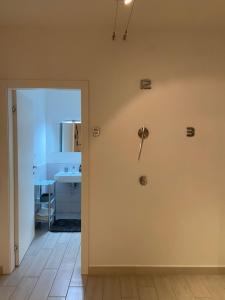 a room with a door with a clock on the wall at Bari Lory’s Home in Bari