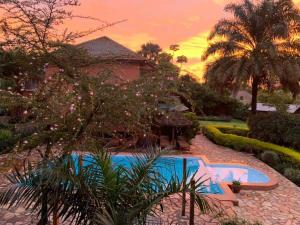 a house with a swimming pool in a yard at Surjios Guest House in Jinja