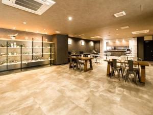 a restaurant with tables and chairs in a room at Hotel Area One Ise Inter in Ise