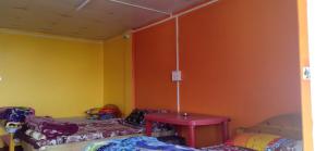 a room with two beds and a table in it at Heaven Valley in Pedong