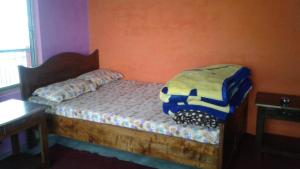 a bedroom with a bed with a blanket on it at Vamoose Heema Homestay in Ghum