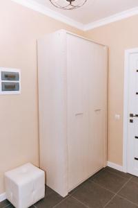 a white closet with a stool in a room at Hotel Nika in Essentuki