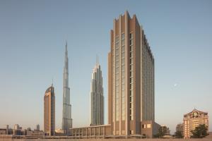 
a tall building with a clock on top at Rove Downtown in Dubai
