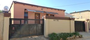 a house with a gate and a fence at Ext4 Guest house in Roodepoort