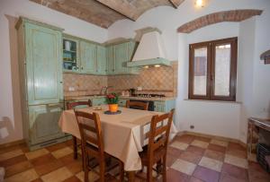 a kitchen with a table and chairs in a room at CasaMatta2 in Isola del Giglio