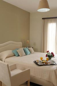 Ένα ή περισσότερα κρεβάτια σε δωμάτιο στο Athena Hotel 