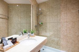 een badkamer met een wastafel en een douche bij UP ROOMS BANYOLES in Banyoles