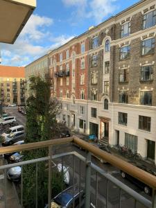 a view from a balcony of a building with a parking lot at ApartmentInCopenhagen Apartment 510 in Copenhagen