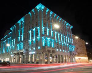 a building with blue lights on the side of it at Motel One Wien-Staatsoper in Vienna
