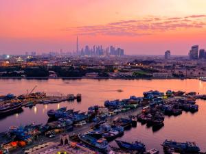 a group of boats docked in a harbor at sunset at Rove City Centre in Dubai