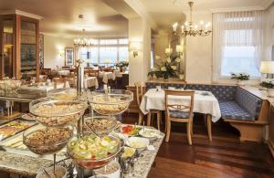 a restaurant with a buffet of food on a table at Apartments Monbijou in Westerland (Sylt)