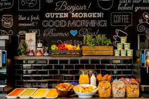 a counter with many different food items on it at Motel One Edinburgh-Royal in Edinburgh