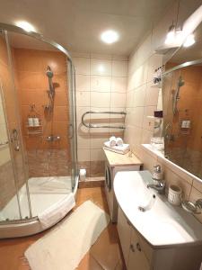 a bathroom with a shower and a sink at Cozy Home Apartment Lielvardes, free parking, self check-in in Rīga +14 photos