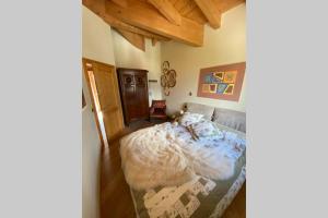 a bedroom with a bed in a room with wooden ceilings at COTTAGE LA VILLA in Oga