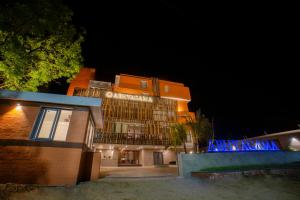 a building with a sign in front of it at night at Abhyagama Hotel in Digha