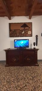 a flat screen tv sitting on a wooden entertainment center at Casa La Fornace in Fornacette +13 photos