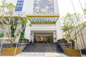 a stairway leading to the entrance of a building at White Lotus Hue Hotel in Hue