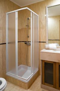 a shower with a glass door in a bathroom at Casa amigavel do Mar in Sesimbra +23 photos