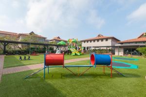 a playground with two play equipment in a park at Beautiful 1 Bed Zimbali Suites with Garden in Ballito