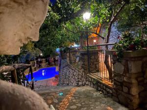 a swimming pool at night with a fence and a fence at One bedroom appartement with sea view shared pool and enclosed garden at Badolato in Badolato