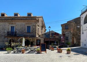 a group of tables in front of a building at One bedroom appartement with sea view shared pool and enclosed garden at Badolato in Badolato