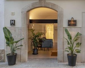 a hallway with two potted plants in a lobby at Alta House Begur in Begur