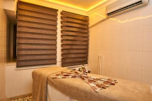 A bed or beds in a room at Amber Hotel & Spa