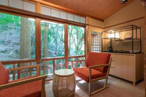a room with a chair and a window at Tsukihitei in Nara