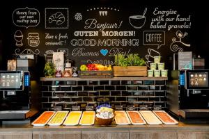 a counter topped with lots of different types of food at Motel One London-Tower Hill in London