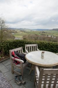 a table and two chairs with a table and a table and chairs with a view at Mason's Arms in Bowland Bridge