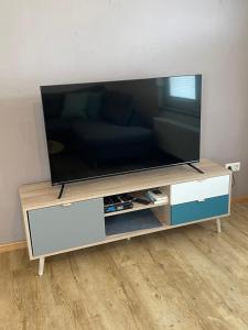 a flat screen tv sitting on a entertainment center at Ferienwohnung Lavendel in Lahr