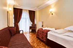 A bed or beds in a room at Amber Hotel & Spa