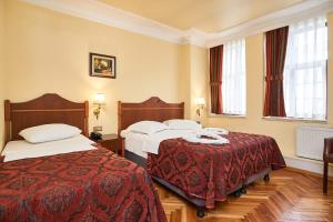 A bed or beds in a room at Amber Hotel & Spa