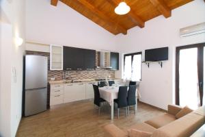a kitchen with a table and chairs and a refrigerator at Villa Giusi in Tropea