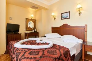 A bed or beds in a room at Amber Hotel & Spa