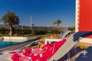 a slide next to a swimming pool with a table at Villa Clara Country Retreat in Solarino