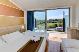 Postel nebo postele na pokoji v ubytování Hotel Rivus