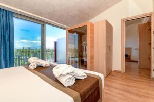 Postel nebo postele na pokoji v ubytování Hotel Rivus