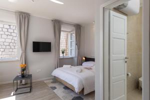 Posteľ alebo postele v izbe v ubytovaní Apartments Urbis