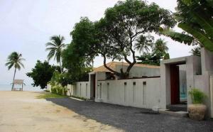 a white building with a tree on top of it at Pao Jin Poon Villa in Lamai
